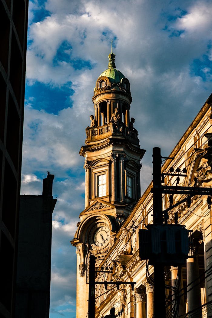 services-bg A prominent historical clock tower stands against a vibrant blue sky in Santos, Brazil.